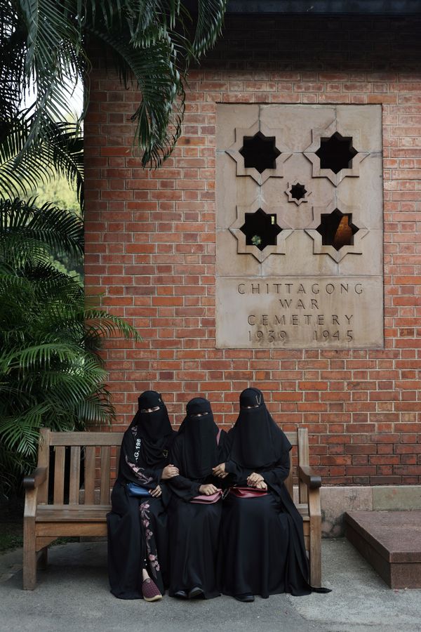 Girls pose for photo at the 2nd World War Cemetery thumbnail