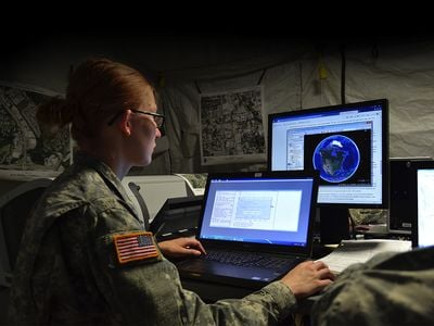 Geospatial engineer Private Miranda Yost of the 117th Space Battalion works with software that helps troops and emergency response teams target locations.