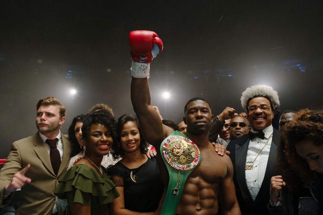 Mike Tyson raising his boxing glove after a victory