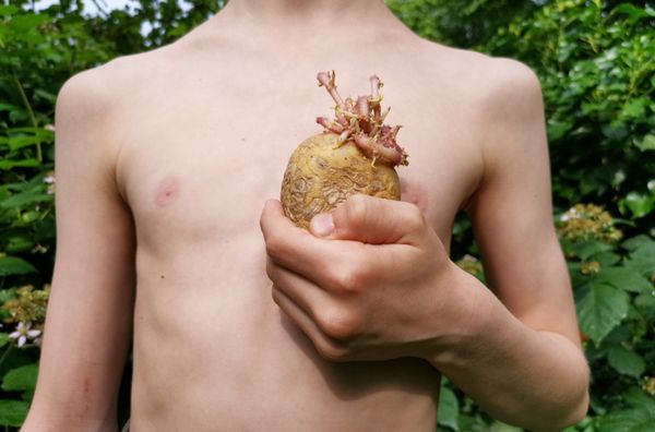 Boy holding a potato in shape of a heart thumbnail