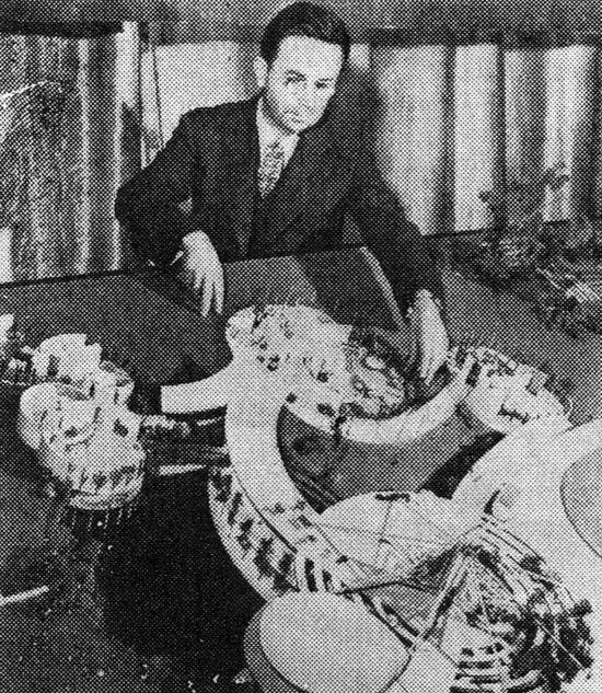 Alden B. Down with a plastic house he designed (1944)