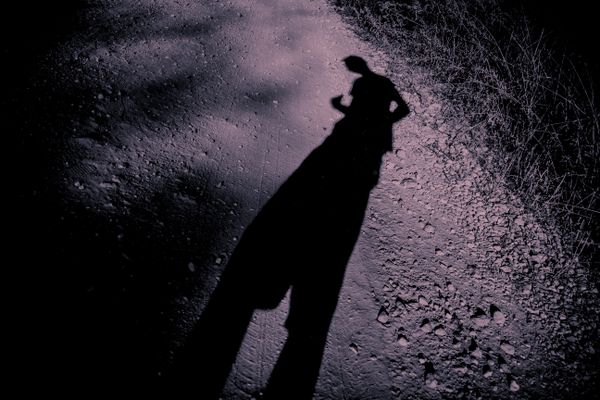 Elongated shadow of a man on gravel thumbnail
