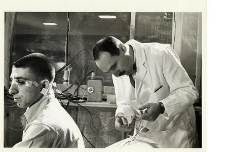Neuroscientist Eugene Aserinsky attaches electrodes to his son, Armond, who was a frequent subject in his early sleep studies
