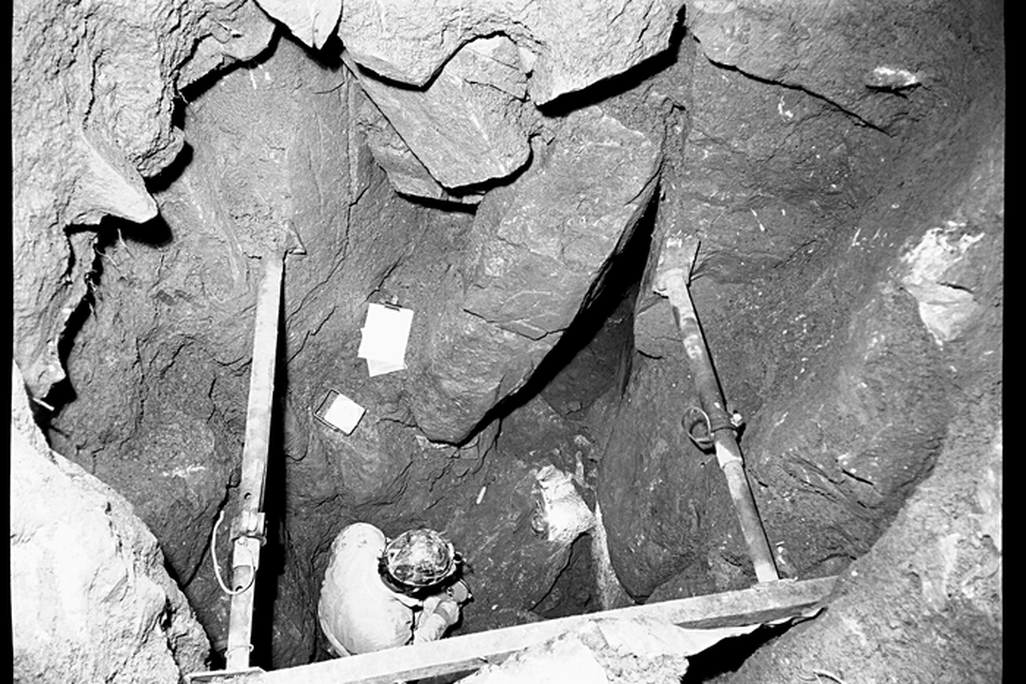A person standing in a deep shaft