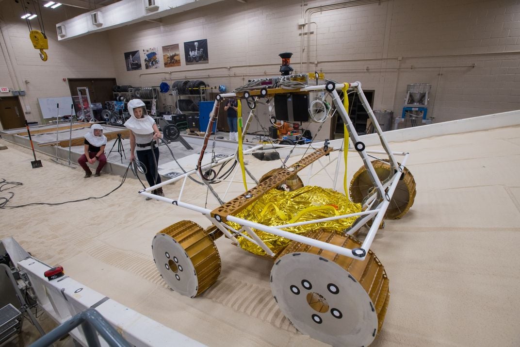 The new lunar rover undergoes testing in NASA’s Lunar Operations Lab as it climbs a sandy bank