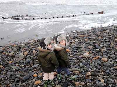 In March 2018, brothers Griffin, left, and Maxwell Bean of Berwick stand at the edge of Short Sands Beach on Tuesday for a rare glimpse of a shipwrecked sloop that emerged from the sand during recent heavy surf.