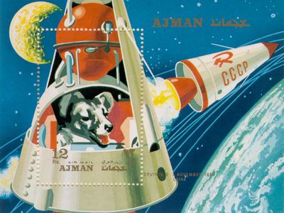 The story of Laika (above, in a postage stamp from the Emirate of Ajman, now part of the UAE) lives on today in websites, YouTube videos, poems, and children’s books, at least one of which provides a happy ending for the doomed dog. 