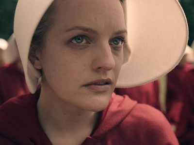 Elisabeth Moss dons the iconic red robe and white bonnet of the handmaid for the new series debuting April 26.