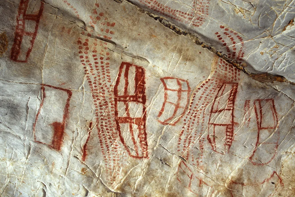 red ochre paintings depict rooflike shapes in a cave
