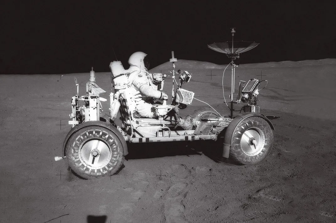 astronaut drives lunar rover on the moon