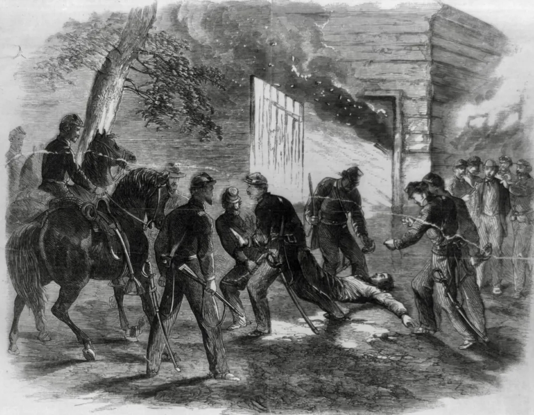 An illustration of Union soldiers dragging the dying Booth out of Garrett's tobacco barn