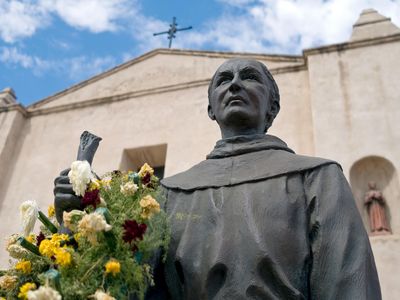 A statue of Junipero Serra, Catholicism's newest saint, stands in front of San Gabriel Arcángel, the California mission he founded in 1771. 