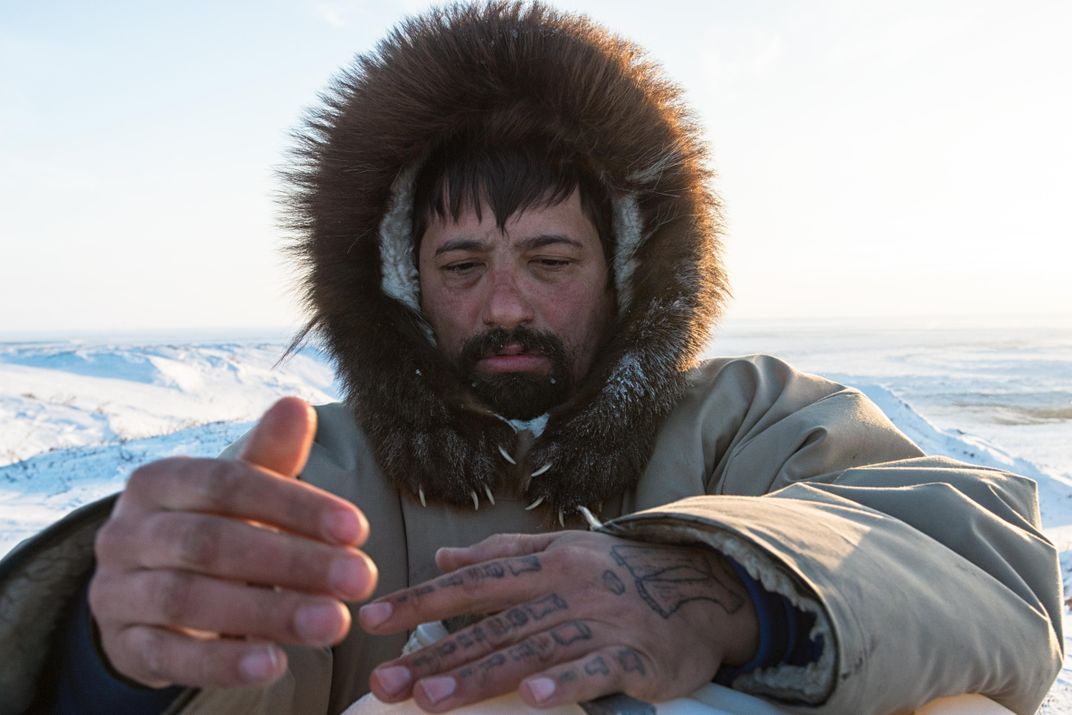 Inupiat hunter Qaiyaan Harcharek wears a parka lined with wolverine fur