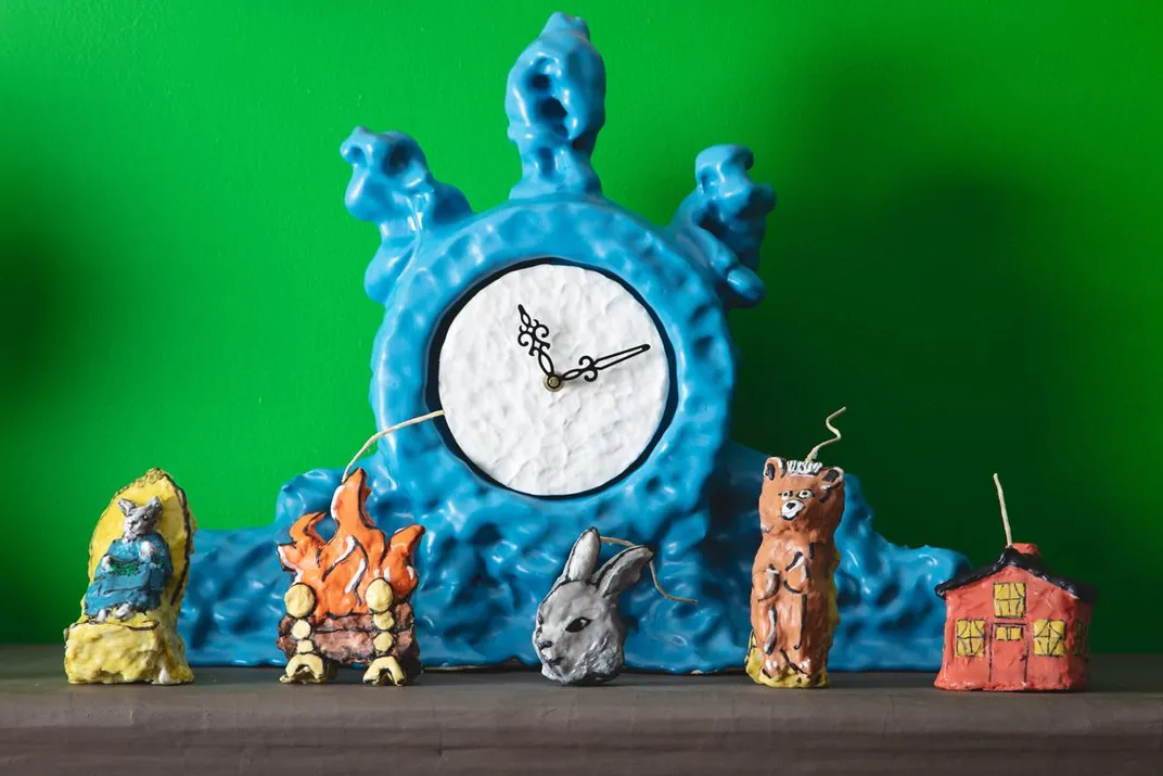 Detail of ceramic mantlepiece clock by Keith Simpson and <em>Goodnight Moon</em>​ character-inspired candles by Janie Korn