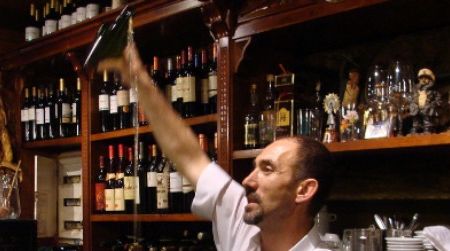 In northern Spain, pouring apple cider from bottle to glass is a sport requiring dexterity and skill, as demonstrated by this barman in La Calzada, Asturias.