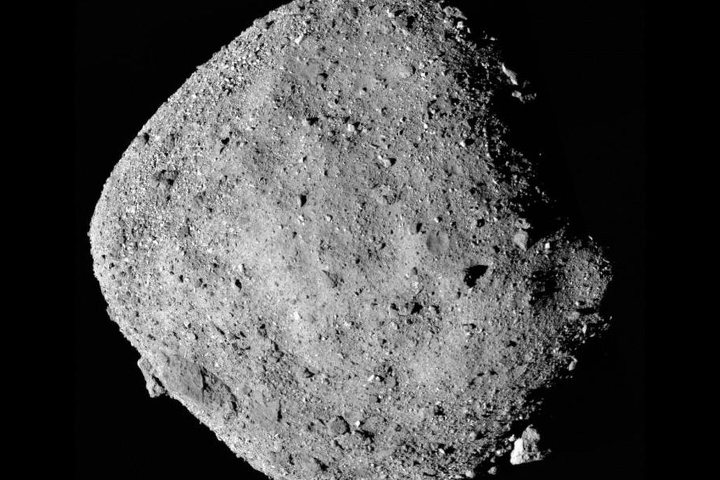 A composite image of asteroid Bennu with a shadow on its right