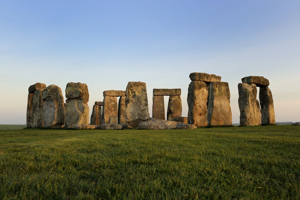 stacks of stone slabs on a green field