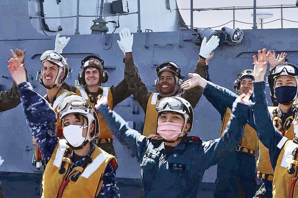 people in masks celebrating on Japanese ship