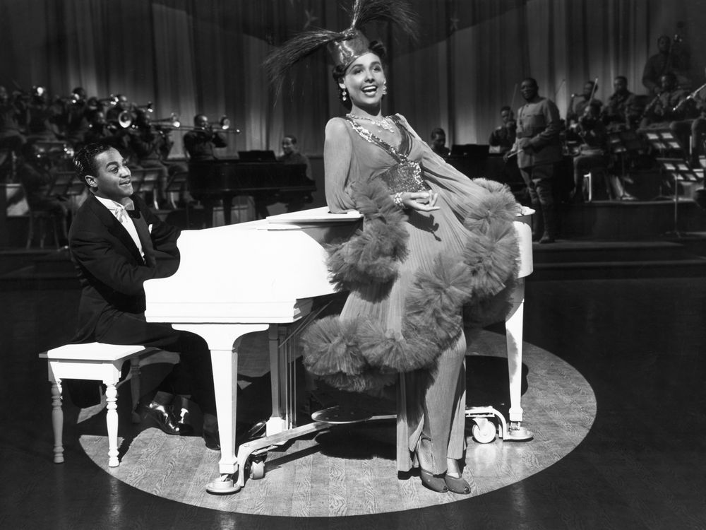 Lena Horne dancing in front of a piano
