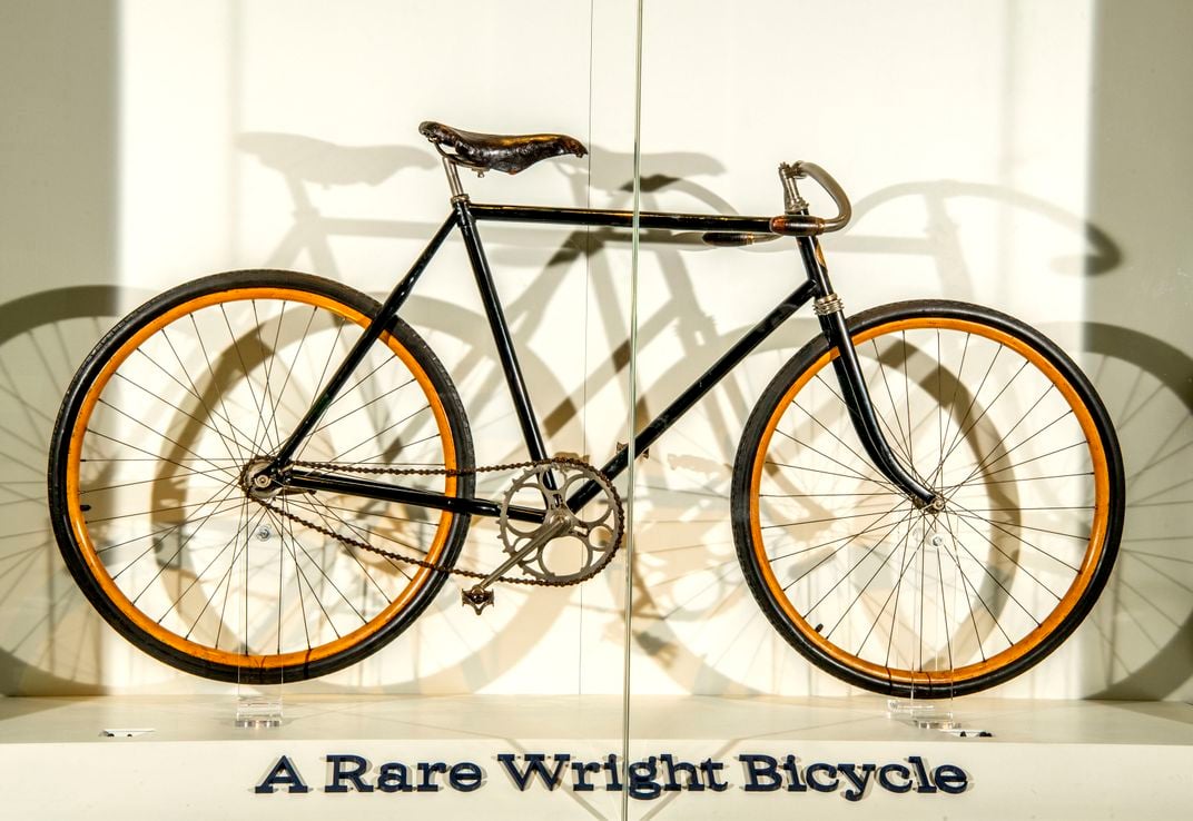 a bicycle in a display case reads "A rare Wright bicycle"