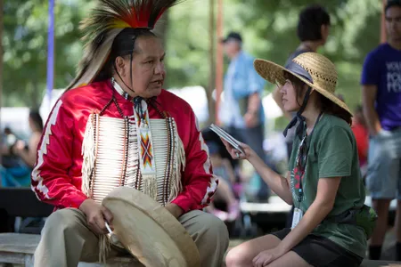Elisa Hough interviews Dennis Zotigh (Kiowa/San Juan Pueblo/Santee Dakota), a cultural specialist at the National Museum of the American Indian. (Daniel Martinez, Center for Folklife and Cultural Heritage, Ralph Rinzler Folklife Archives.)