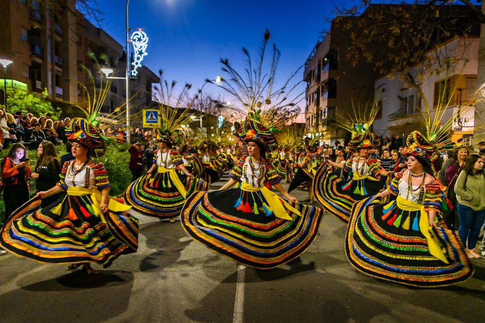 dancers in colorful outfits in a parade
