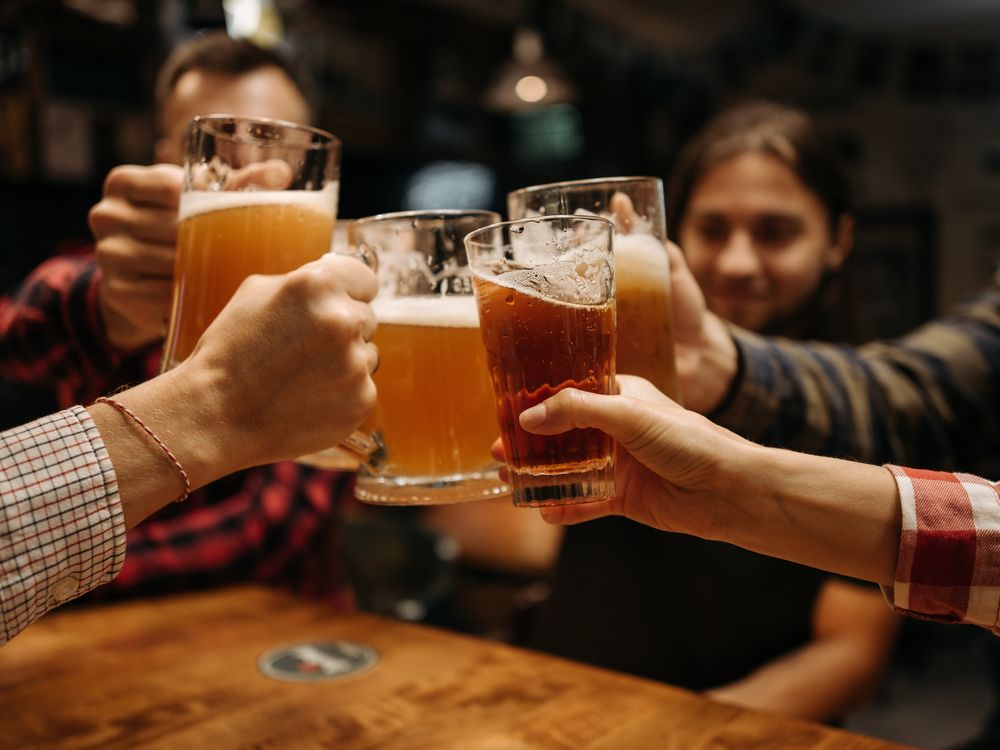 People cheersing their beers together