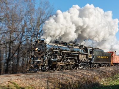A steam locomotive with smoke billowing
