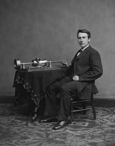 Thomas Edison poses with an early phonograph.