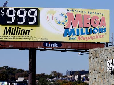 A Mega Millions billboard in Omaha, Nebraska, adjacent to a Sears store, shows $999 million, the maximum number it can show, 