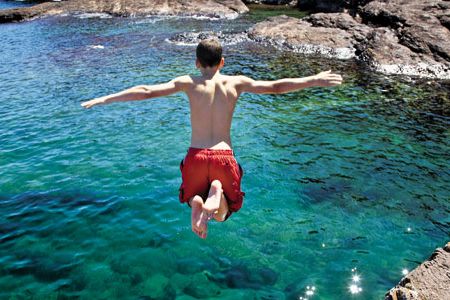 Northern Michigan's rocky coast, shown here is a Presque Isle cove, has long beckoned as a summer playground. The picturesque region, wrote American naturalist Edwin Way Teale, is "a land of wonderful wilderness."