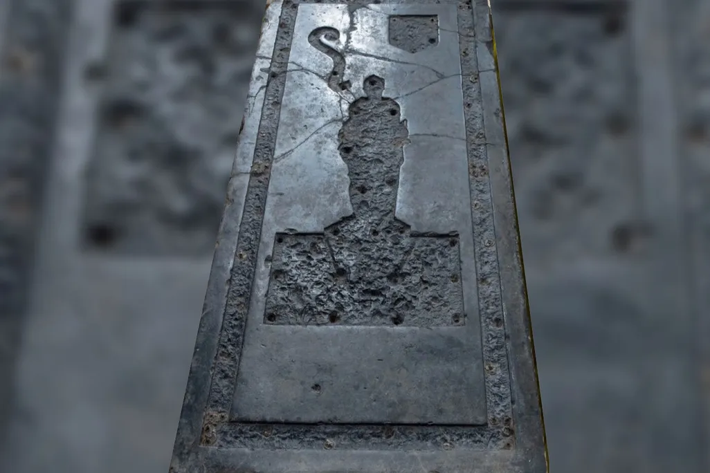 Black slab of stone with indentation