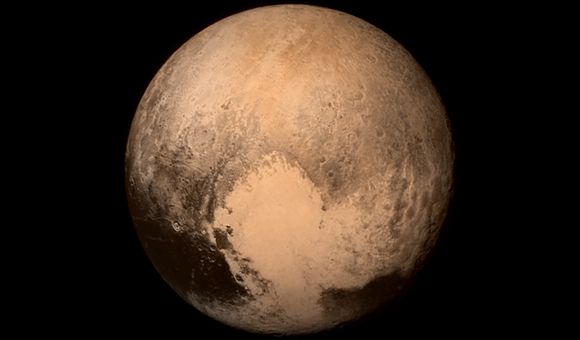 A photograph of Pluto shows patches of beige, black and grey areas mottled with spherical shapes and many other unidentified features.
