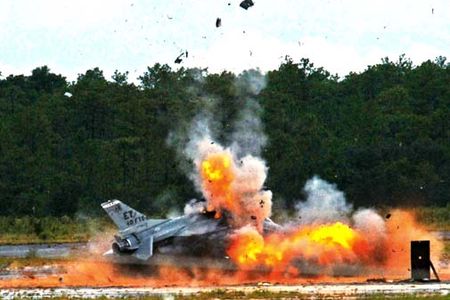 An F-16 Fighting Falcon explodes, sending debris and shrapnel into the air Aug. 19, 2010, on the range at Eglin Air Force Base, Fla. The explosion was a static test of the flight termination system to be used in the QF-16, a supersonic reusable full-scale aerial target drone modified from an F-16. The purpose of the test was to demonstrate that the FTS design will be sufficient to immediately terminate the flight of a QF-16, as well as to determine a range safety debris footprint. (U.S. Air Force photo/Samuel King Jr.)