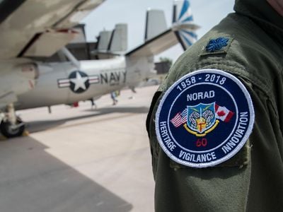 A patch notes the 60th anniversary of NORAD.