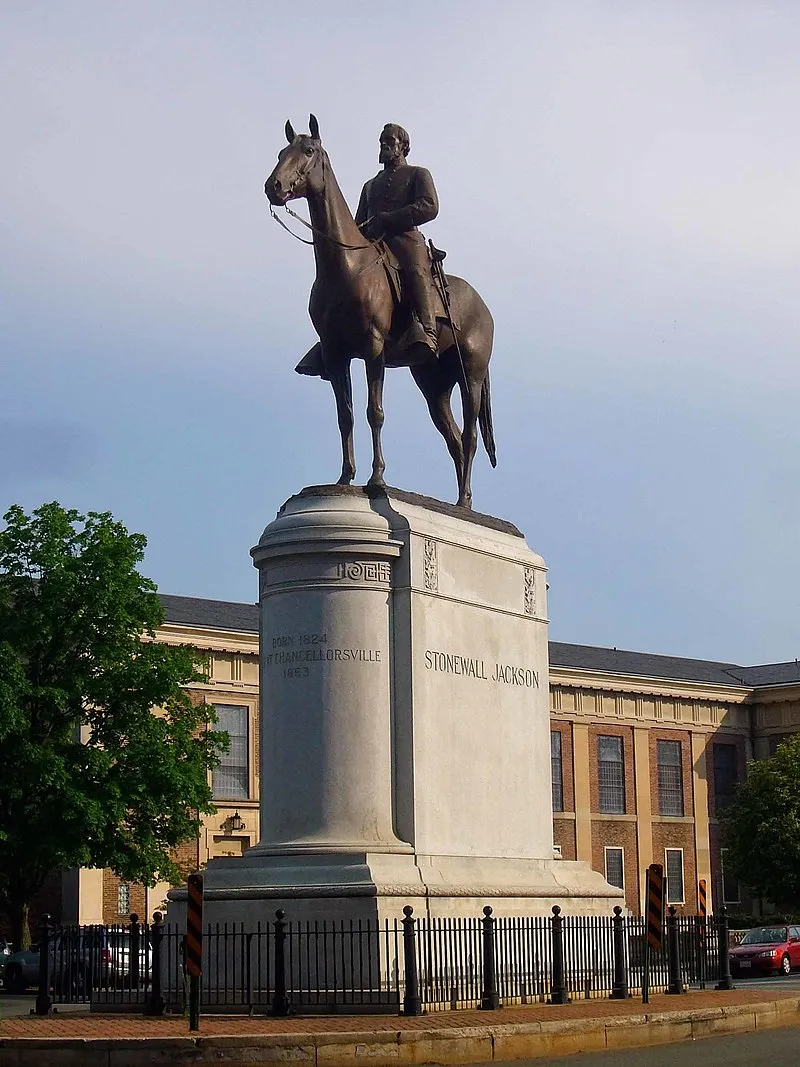 A statue of Stonewall Jackson on a horse, positioned in the center of a large street