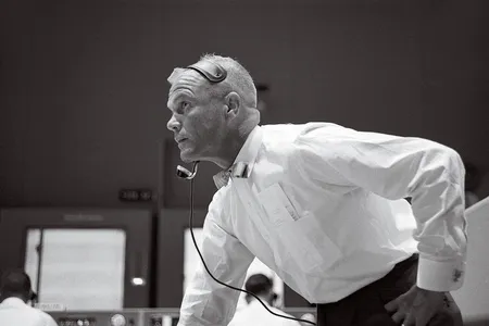 John Glenn’s crisp white shirt is sharp against a soft-focus control center. He’s watching the unpiloted Mercury-Atlas 4 flight in September 1961, just months before he would climb aboard the Friendship 7 spacecraft and ride an Atlas rocket on the same profile to orbit. 