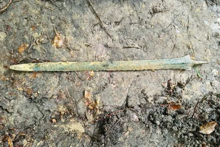 The bronze sword measures nearly two feet long.