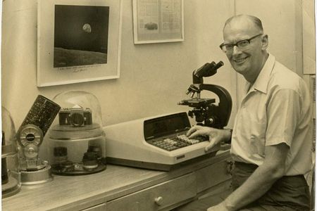 Arthur C. Clarke poses for a photo while he sits at his desk, circa 1969.