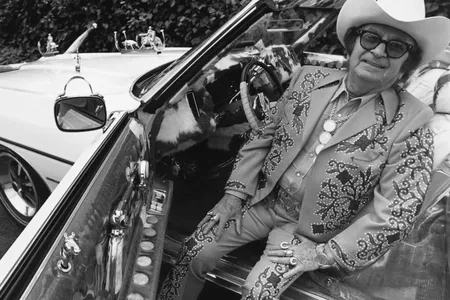 Designer Nudie Cohn sits in his Pontiac convertible.