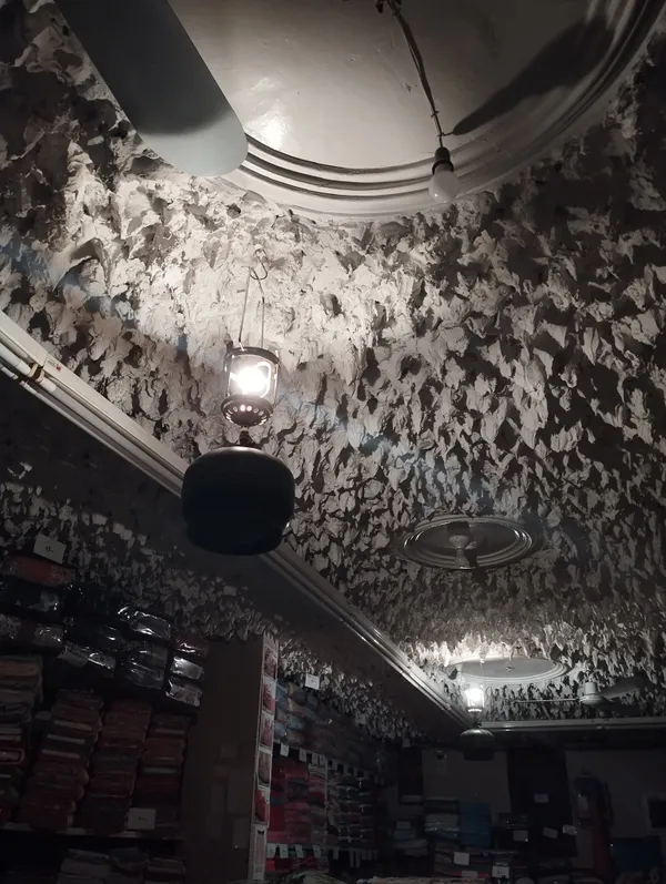 A burning gas lamp in the basement floor of a cloth store thumbnail