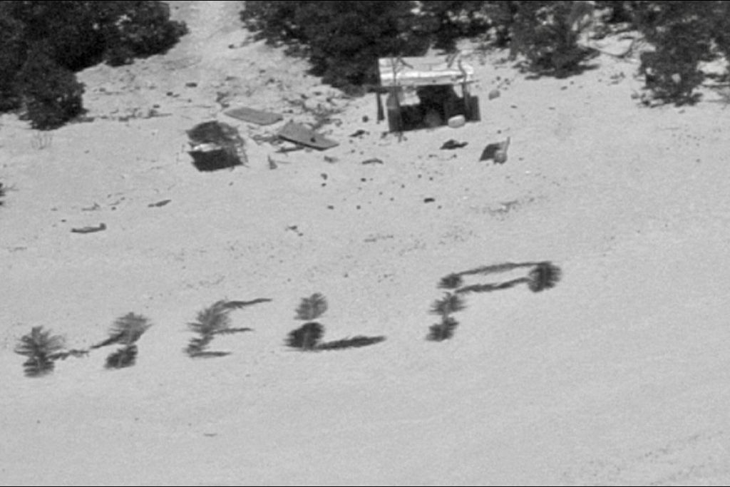 HELP spelled out on beach