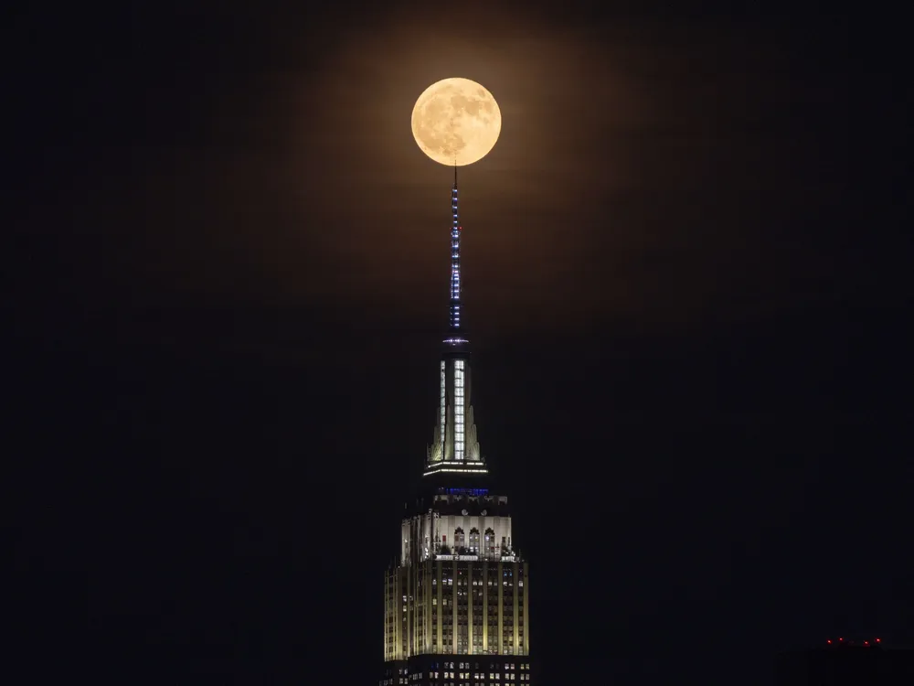 Strawberry moon rises behind the Empire State Building in New York City on June 29, 2026