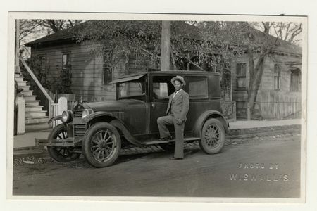 Well-dressed Filipino man with 1920s car in the 1930s