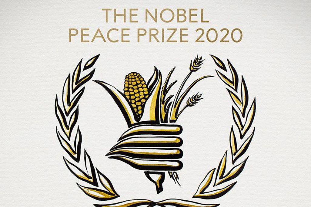 An black and white illustration of a gathering of food-- corn, wheat, surrounded by laurels-- with the text THE NOBEL PEACE PRIZE 2020, with gold accents