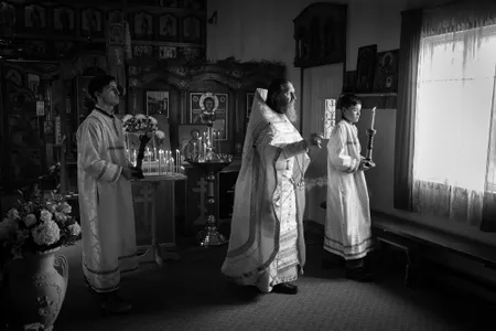 Inside the Church of Saint Nicholas, Father Nikolai Yakunin blesses parishioners during Pascha (Russian Easter), which begins at midnight and ends at dawn. The smoke of the incense is said to lift prayers to heaven.