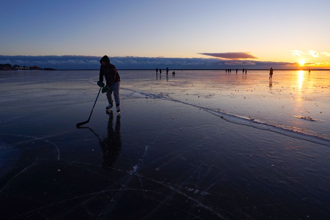 10 - Skaters take to the ice of a frozen Lake Superior.