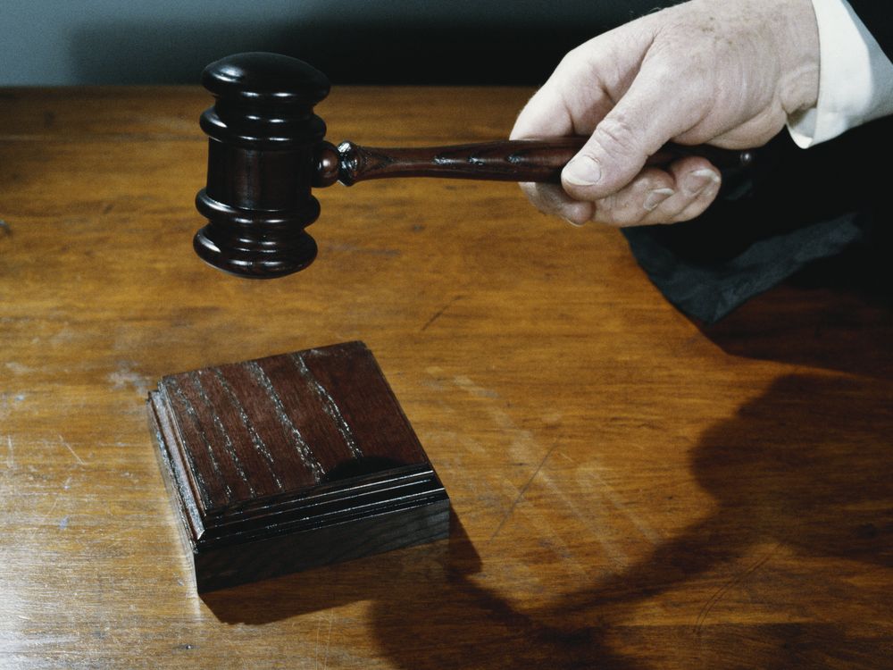 a hand holds a gavel