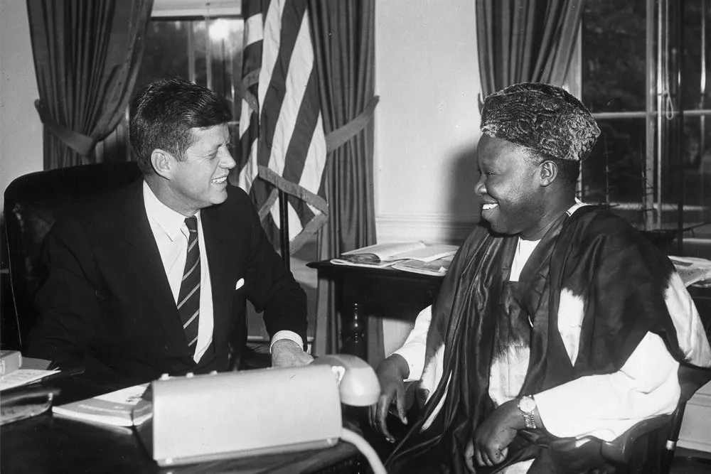 President John F. Kennedy meets with William H. Fitzjohn, charge d'affairs of Sierra Leone, in the Oval Office on April 27, 1961.