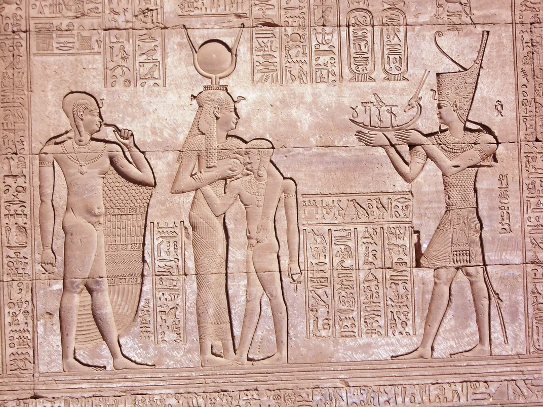 A wall relief of Trajan (right) in pharaonic garb, offering a sacrifice to the goddess Hathor and her son Ihy